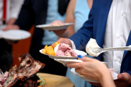 Waiter served roasted meat at the party