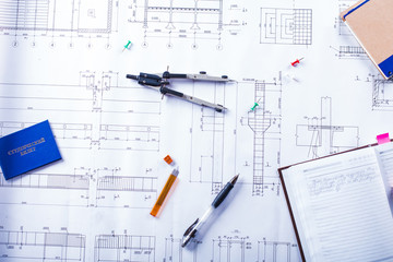 Desktop on which the drawing compasses, pencil and notebook