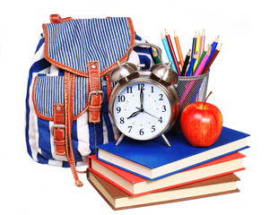 Books, apple, backpack, alarm clock and pencils isolated
