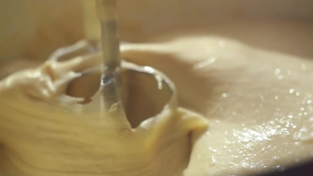 Close-up of slow motion mixing muffin mixture with electric mixer FullHD 1080p