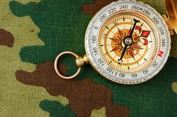 Compass on a camouflage background
