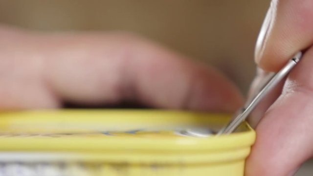 Sardines in can opening close-up of fingers and metal opener 4K 2160p 30fps UltraHD footage - Canned sardines fish in oil opening with hand shallow DOF 4K 3840X2160 UHD video 