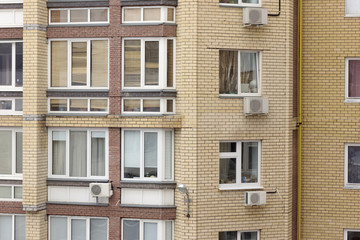 A fragment of a multi-storey brick residential building with installed air conditioning. Nizhny Novgorod. Russia.