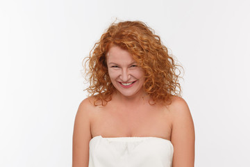 Spiting mature woman posing isolated onwhite background. Beautiful red haired woman looking at...