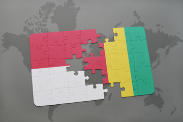 puzzle with the national flag of indonesia and guinea on a world map background.