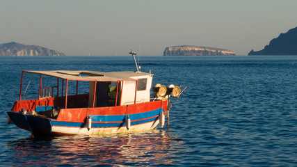Fototapeta na wymiar Sunset with fishing boat - Oia, Santorini