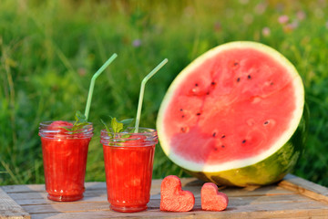 Watermelon red smoothie as healthy summer drink. Bio organic and vegan beverage with hearts.