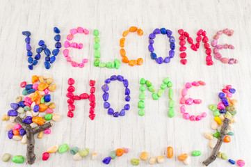 Welcome home note written with small rocks