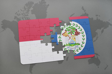 puzzle with the national flag of indonesia and belize on a world map background.