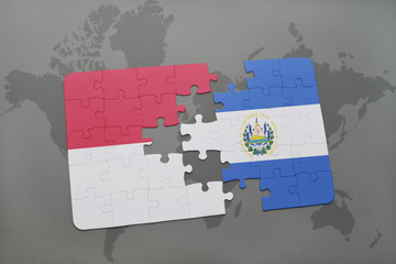 puzzle with the national flag of indonesia and el salvador on a world map background.