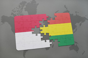 puzzle with the national flag of indonesia and bolivia on a world map background.