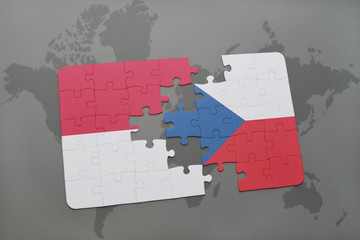 puzzle with the national flag of indonesia and czech republic on a world map background.
