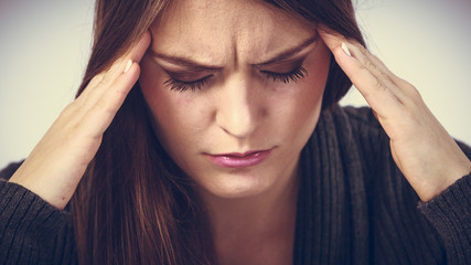 Young woman with painful headache