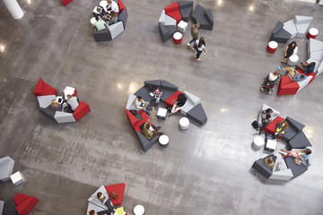 Students groups sitting in a modern university atrium