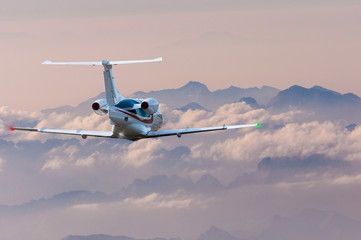 Privat plane or aircraft flight above mountains