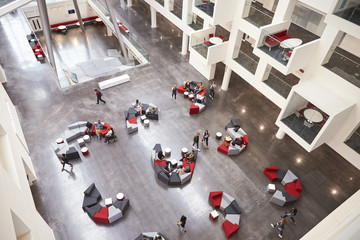Students in the atrium of modern university building, aerial - obrazy, fototapety, plakaty