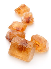 Brown caramelized lump cane sugar cube isolated on white backgro
