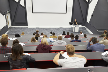 Lecture at university lecture theatre, audience POV