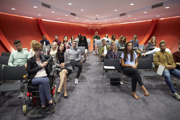 Students sit facing camera in a modern university classroom