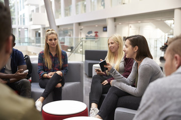 Students meeting in the foyer of modern university building