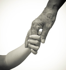 hand of a young baby touching old hand of the elderly
