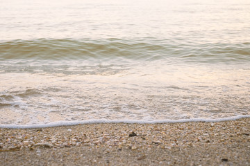 Slow of wave of the sea move to the sand beach at a evening.