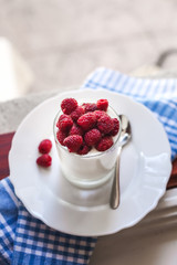 healthy breakfast : yogurt and fresh raspberries