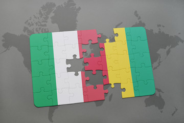 puzzle with the national flag of italy and guinea on a world map background.