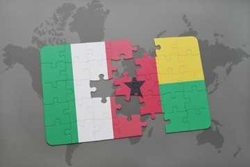 puzzle with the national flag of italy and guinea bissau on a world map background.