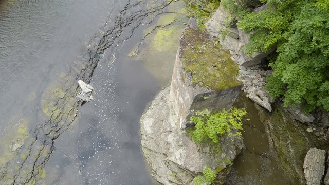 Aerial view of the Narva river in Estonia lots of algae on the big rocks on the middle of the river
