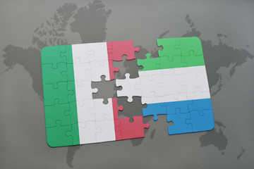 puzzle with the national flag of italy and sierra leone on a world map background.