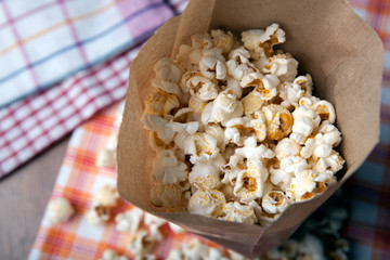 salted popcorn in a paper bag close up