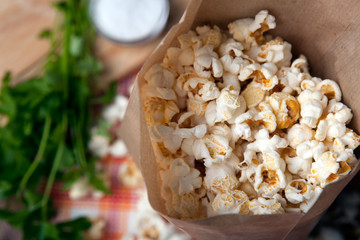 salted popcorn in a paper bag close up