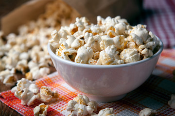 popcorn into a bowl on a napkin in the kitchen