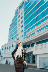 Fashion autumn woman in leather jacket outdoors