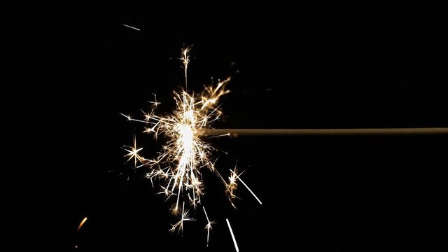 A burning fuse or bengal fire. Isolated on black. Mojo-style coloring. Shiny sparkles.
