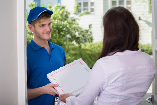 Man Delivering Pizza To Young Woman