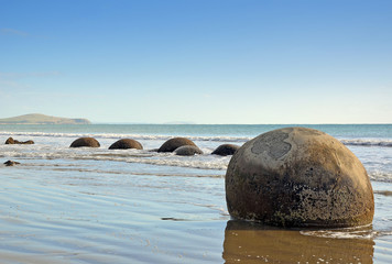 Round rock formations, the Moeraki boulders, on a New Zealand beach