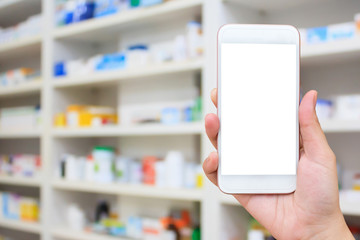Woman using mobile smartphone in the pharmacy