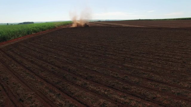 Peanuts mechanized harvesting in Sao Paulo Brazil - Aerial drone craning following tractor harvesting peanuts field
