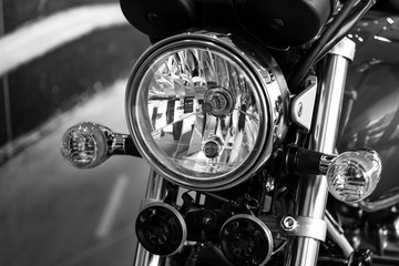 Retro motorcycle with headlights on black and white colors