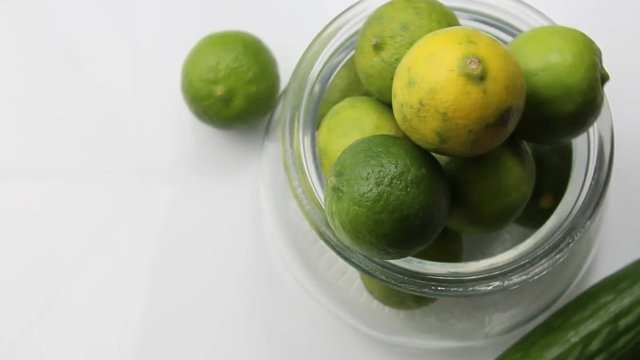 View of green limes in a container from above