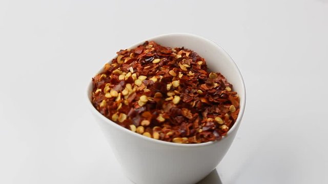 Rotating crushed red pepper in a container