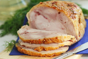 Sliced baked meat with spices and dill