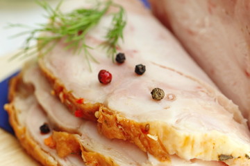 Sliced baked meat with spices and dill