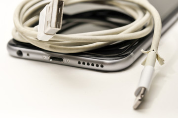 BANGKOK, THAILAND - JUNE 30, 2016 : The broken iPhone charger cable. Focus on damaged part.