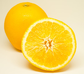 Slice of orange and whole orange on white background