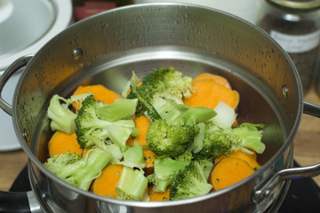 Steaming broccoli and sweet potatoes