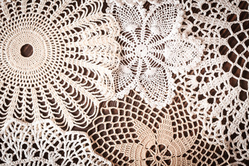 Beautiful delicate vintage lace background of crochet napkins on the table - obrazy, fototapety, plakaty