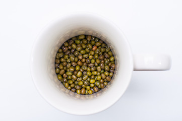 mung bean in cup, ceramic cup white color on white table
